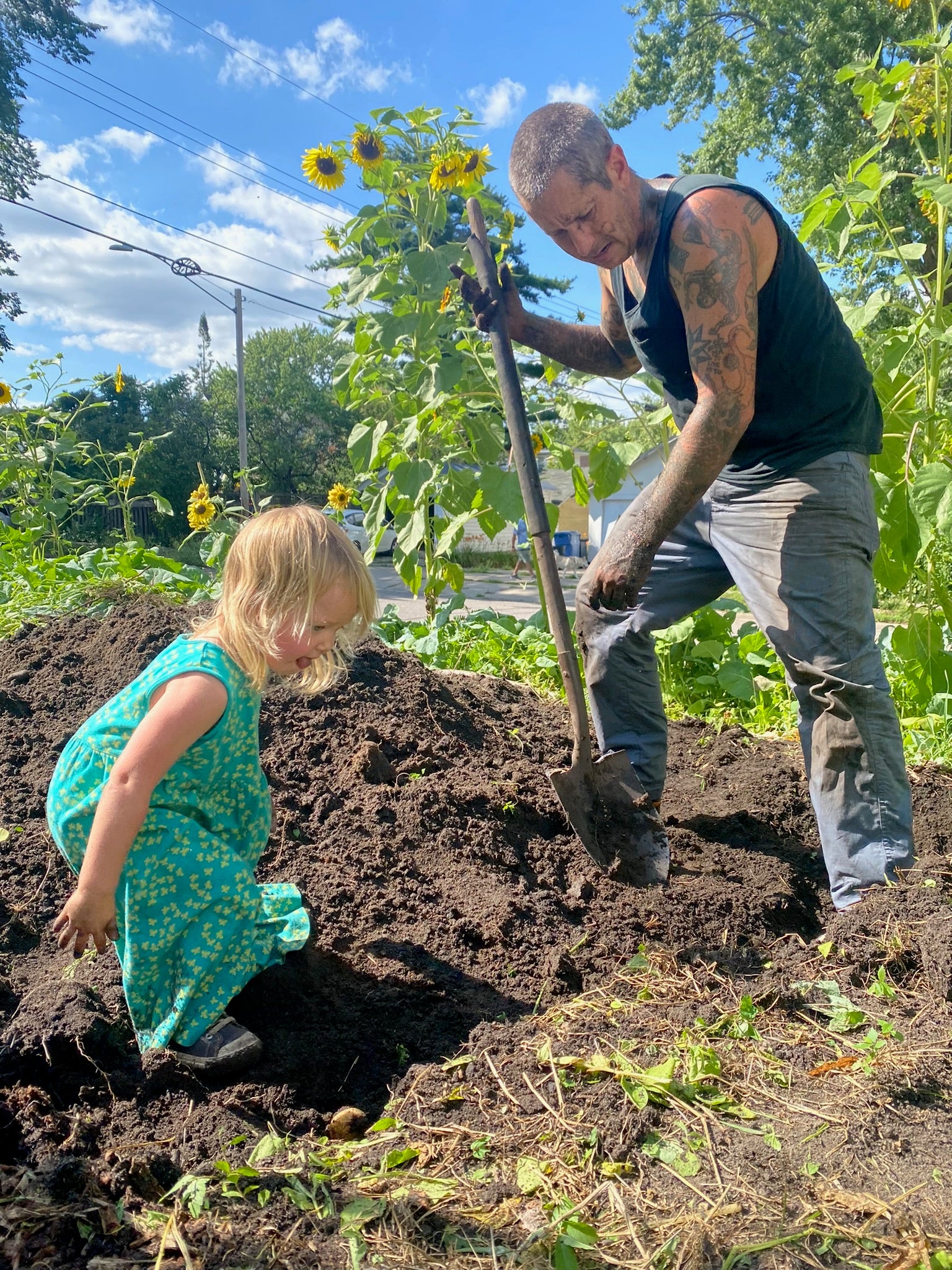 Jade and one of our kiddos working in a The Black Radish Urban Farm garden.